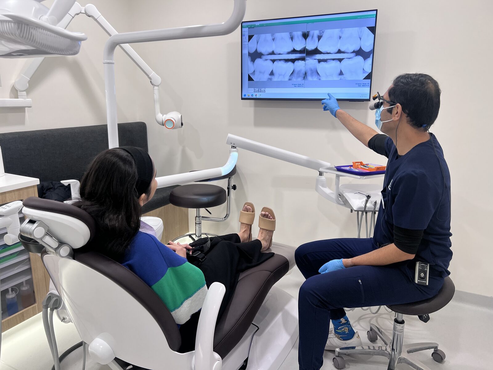 Dr Sunny walking a patient through their X-rays at Smile Spot Mawson Lakes