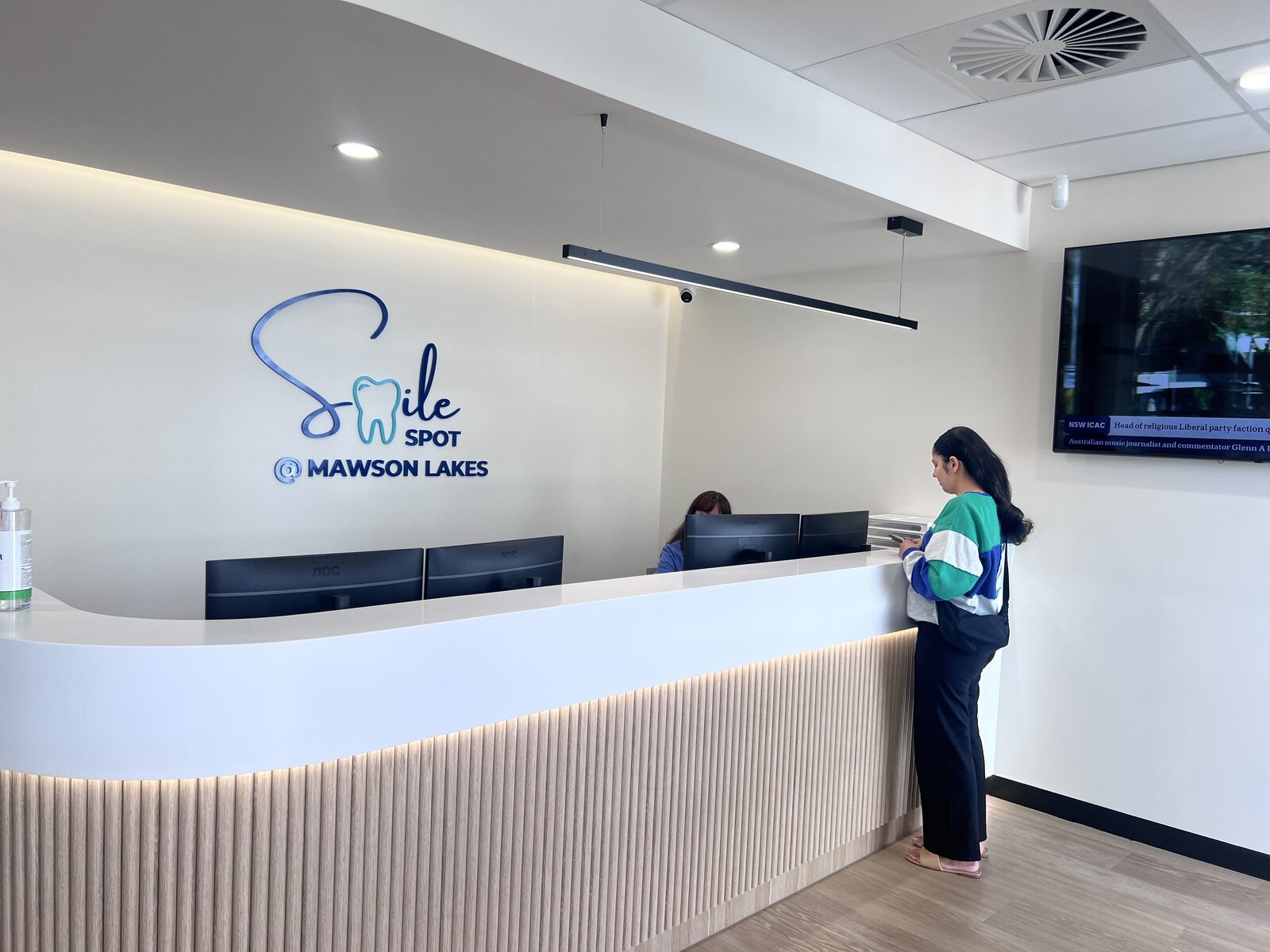 Reception team welcoming a patient at Smile Spot Mawson Lakes